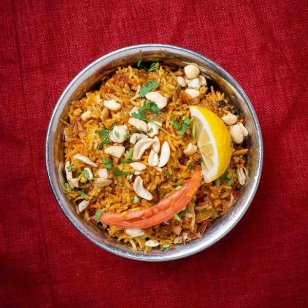 Everest Nepalese & Indian Cuisine's Biryani, a rice dish with cashews, cilantro, lemon, and tomato.